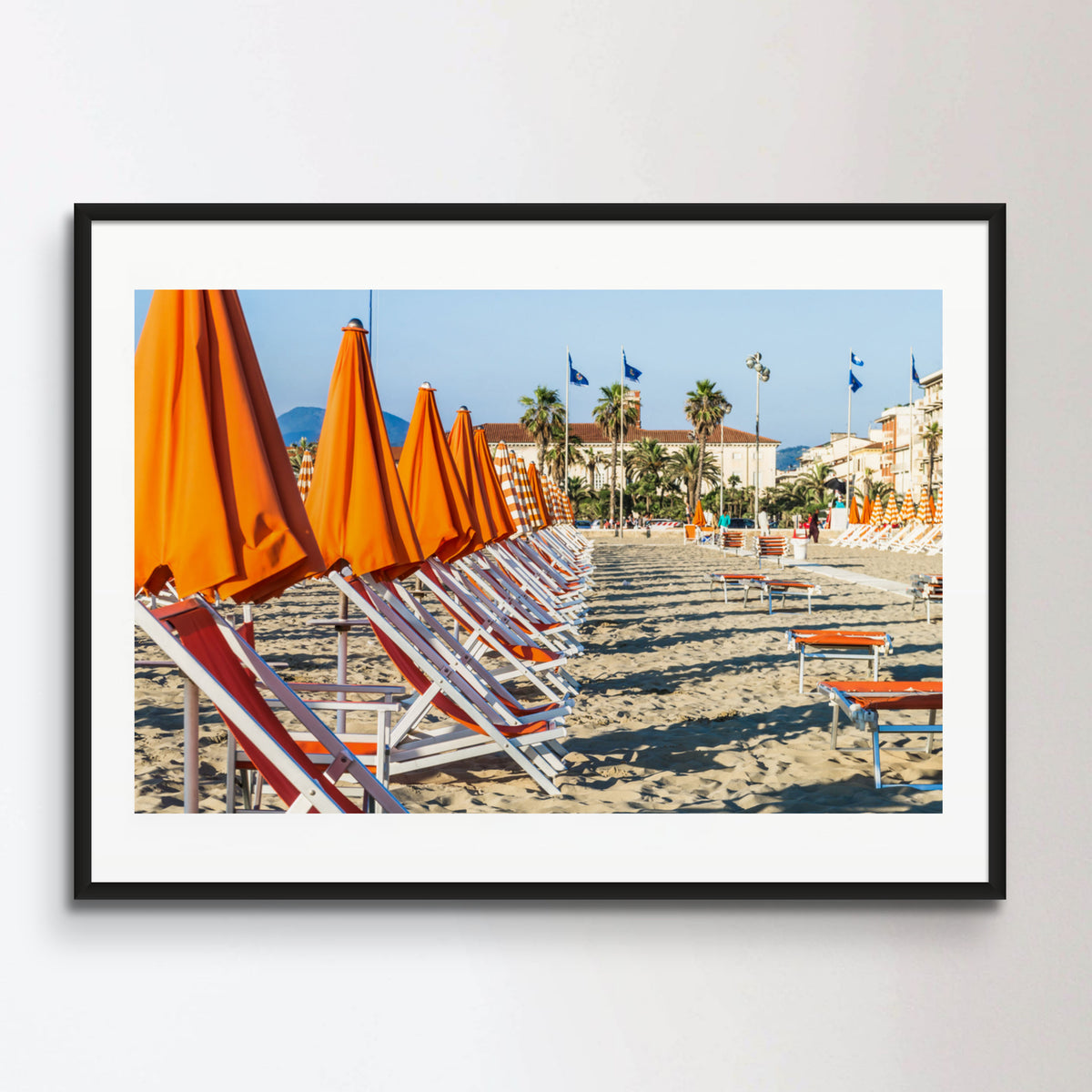 Viareggio beach with colorful umbrellas at sunset, Viareggio, Italy.